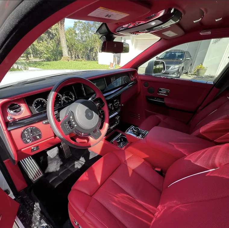 Bright red Mansory leather interior of a Rolls-Royce Phantom, steering wheel and front seats, after a full interior detail by A2D.