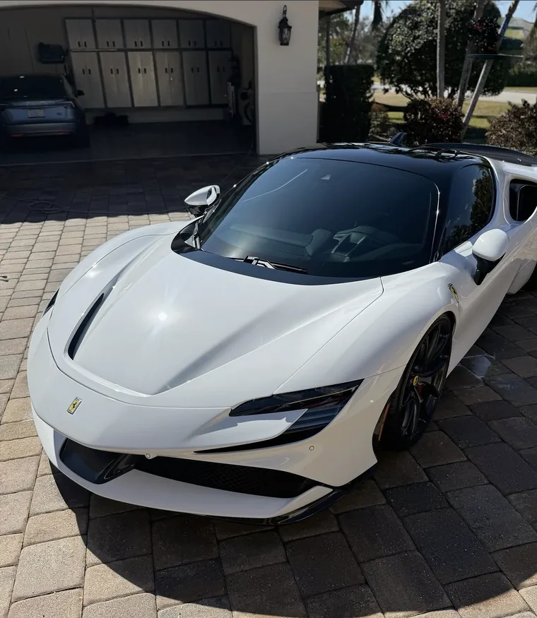 White Ferrari SF90 Stradale in a driveway on Lansing Island after a full exterior detail.